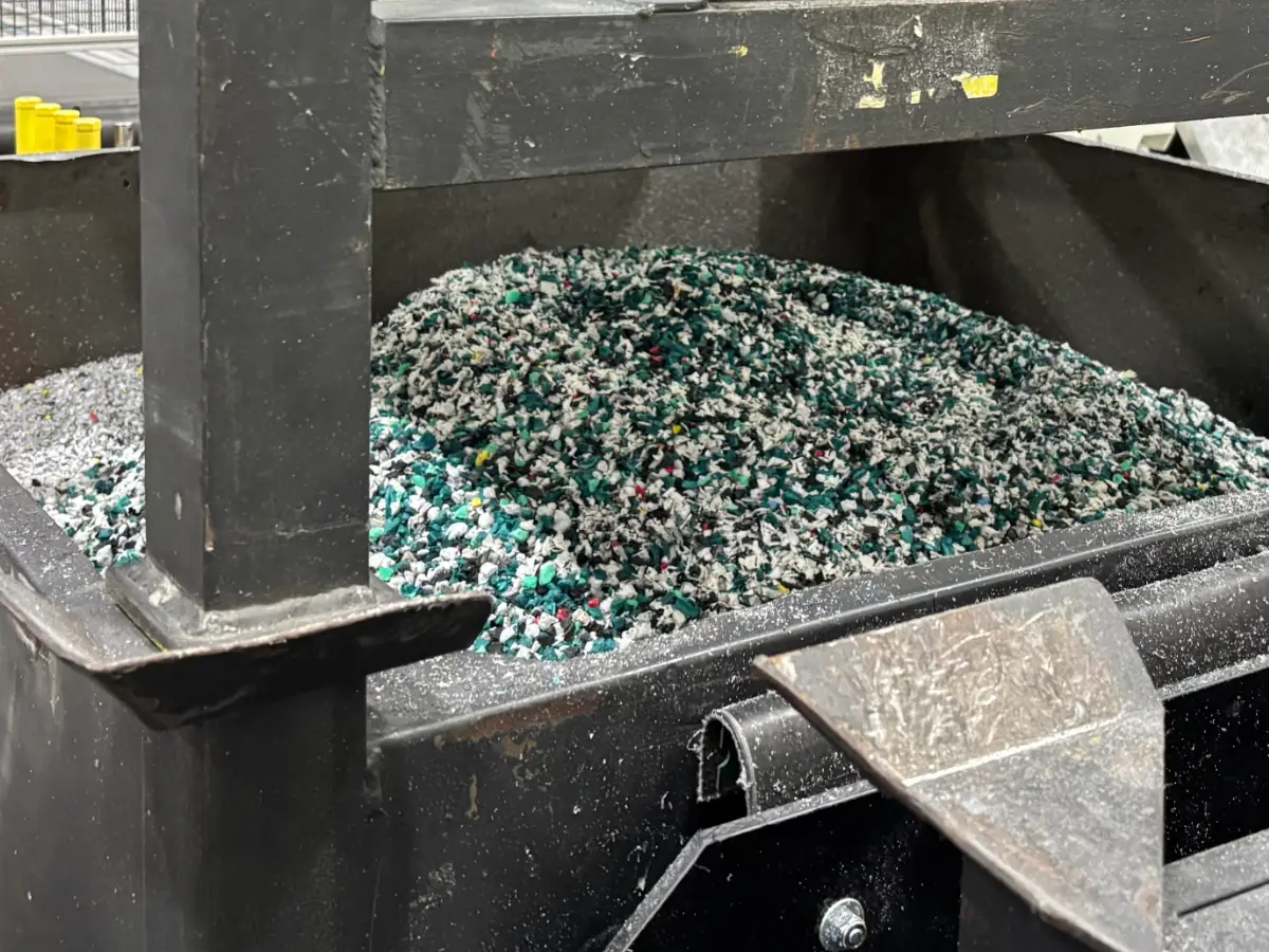 Bin of shredded and reground plastic material