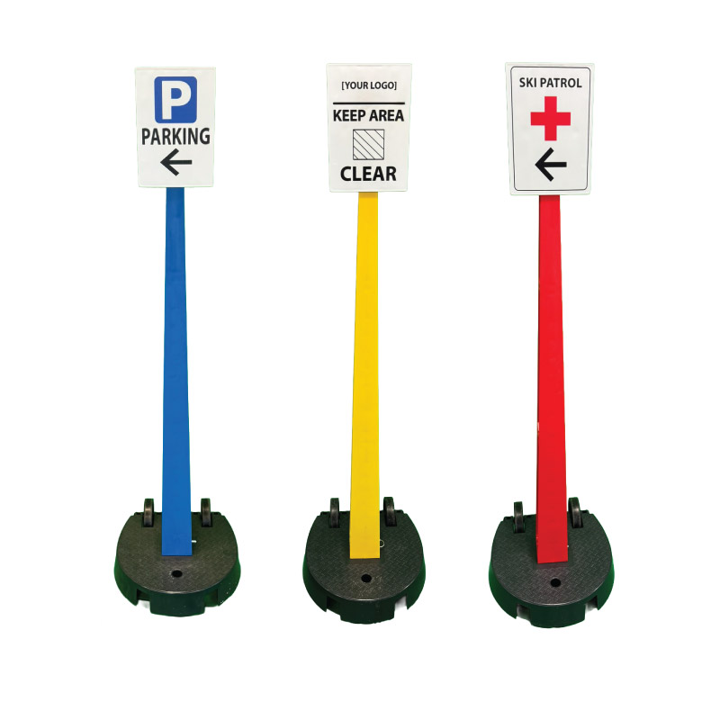 Blue, yellow and red plastic sign posts with parking, keep clear and ski patrol signs