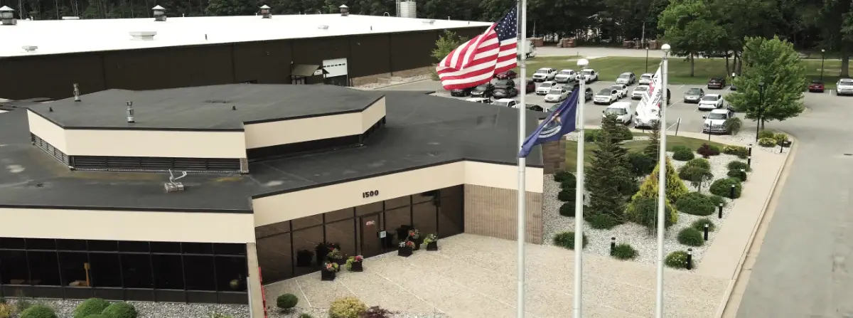 Aerial view of the GHCM corporate office with flags and landscaping