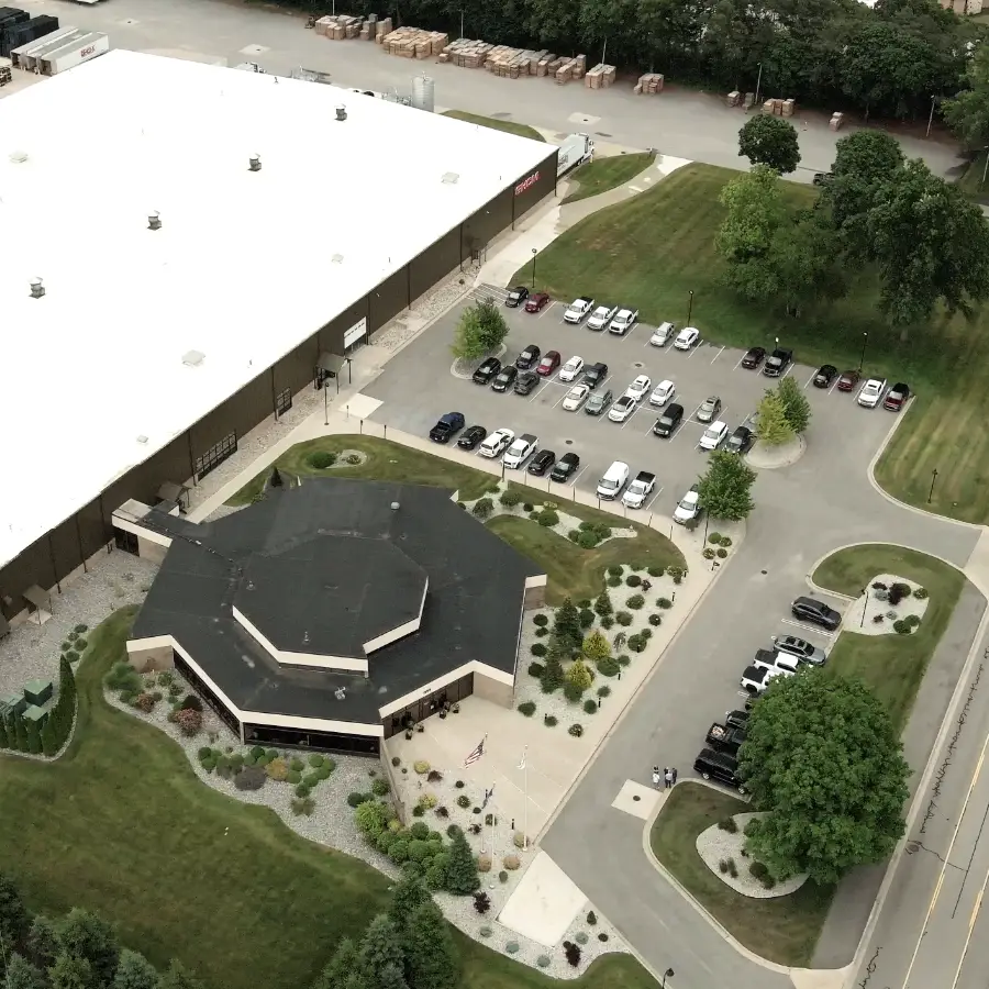 Aerial view of the GHCM corporate office and main plant with parking lot