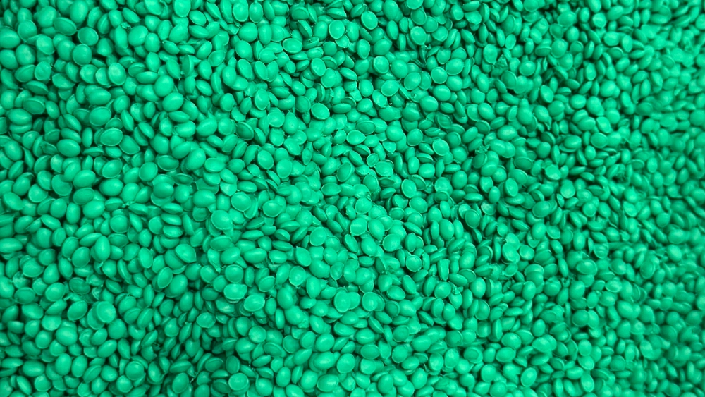 Close-up of green plastic resin pellets