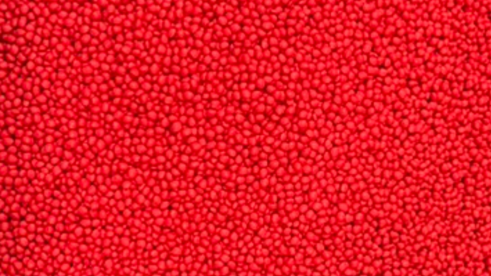 Close-up of red plastic resin pellets