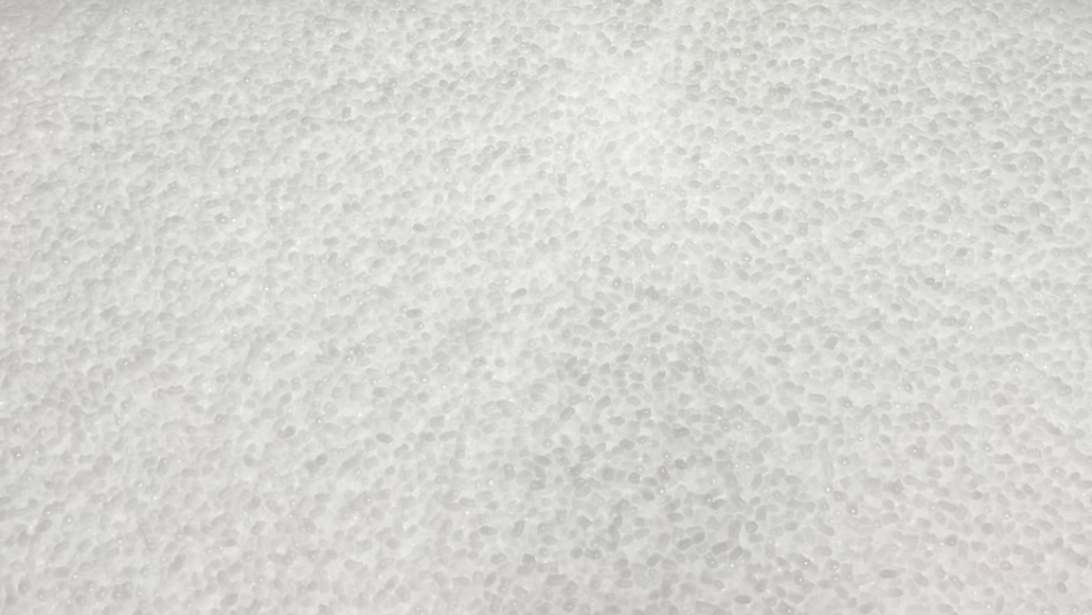 Close-up of white plastic resin pellets