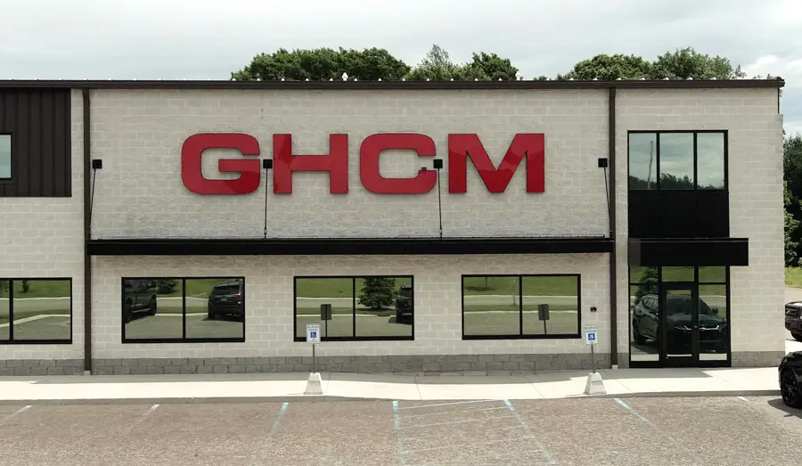 Exterior of a GHCM facility with the red GHCM logo